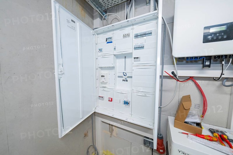 Detailed view of an electrical cabinet with open control boxes in the technical room