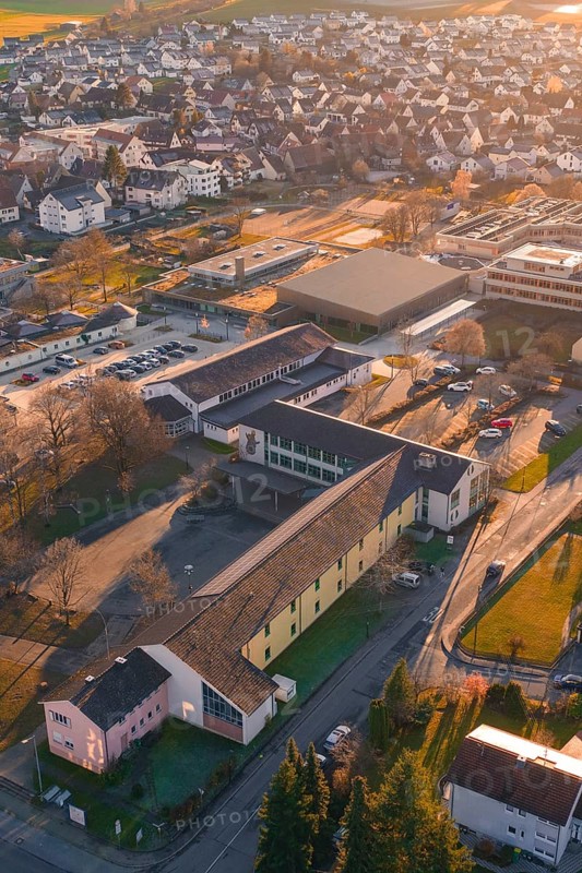 Rural aerial view with school buildings and roads in an autumnal atmosphere, Althengstett, Calw district, Germany