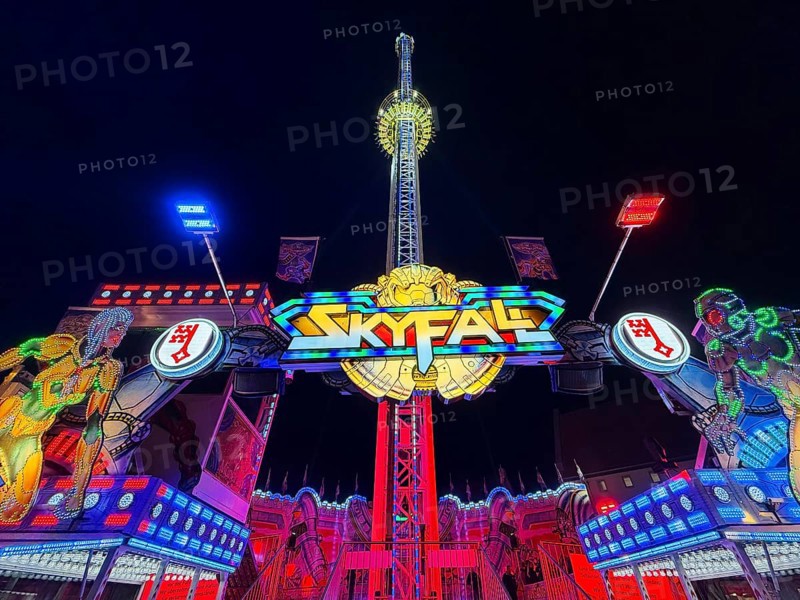 Colourfully illuminated Skyfal free fall tower at night at the All Saints Fair, Soest, North Rhine-Westphalia, Germany