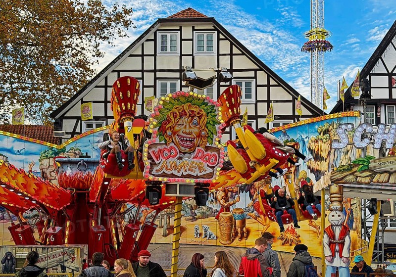 All Saints Fair ride in front of half-timbered houses, largest old town fair in Europe, Soest, North Rhine-Westphalia, Germany