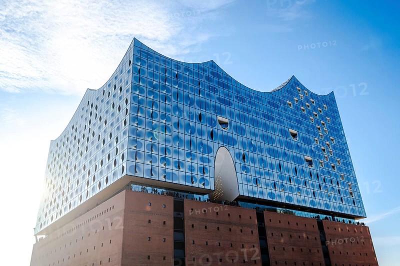 The modern Elbe Philharmonic Hall with its unique glass façade rises majestically against the blue sky in Hamburg, Hamburg, Germany
