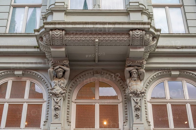 Caryatids at the bottom of a bay window in a historic residential building, 19th century, Hanseatic City of Lübeck, Schleswig-Holstein, Germany