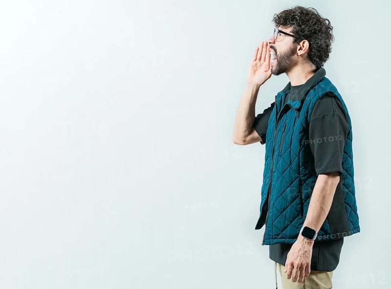 Male person shouting an announcement isolated. Casual young man in glasses shouting a promotion