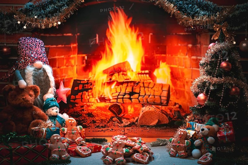 Plate of cookies in front of a fireplace with sparkling Christmas decorations and toys