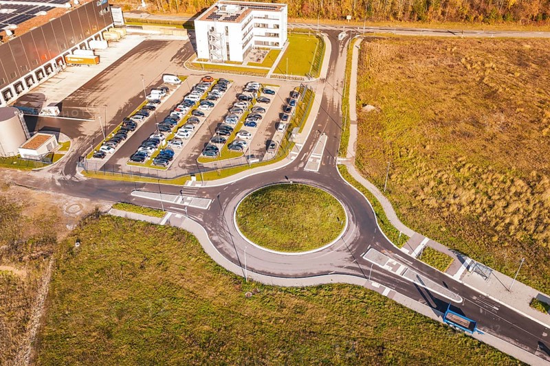 Roundabout and buildings in an autumn environment from the air, new Lindenrain industrial park, Calw, Black Forest, Germany