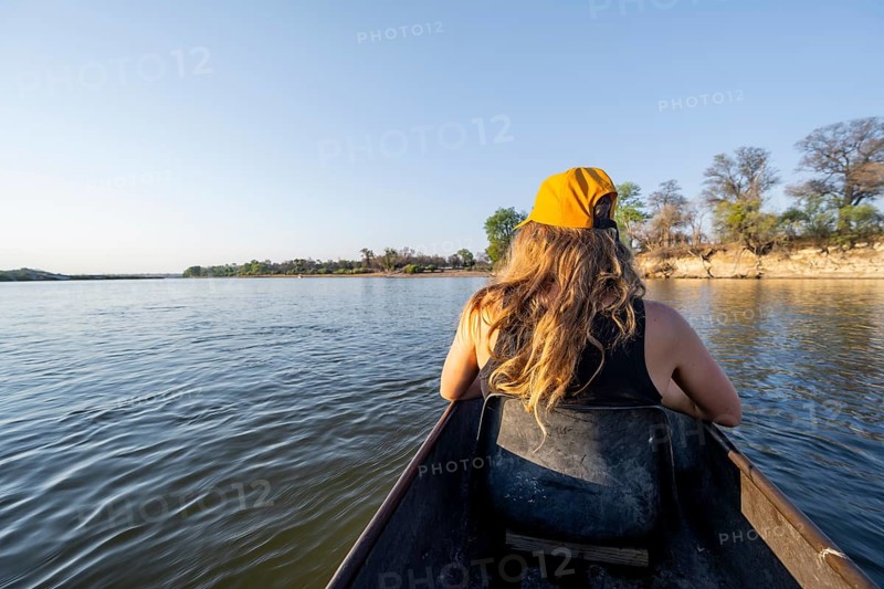 Tourists in a Mokoro, dugout boat on the Okavango River, Caprivi Strip, Namibia
