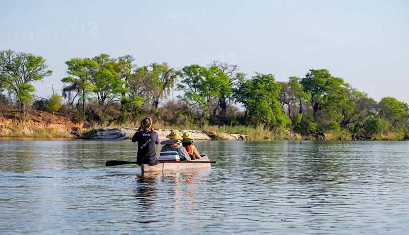Boat trip, tourists in a Mokoro, dugout boat on the Okavango River, Caprivi Strip, Namibia