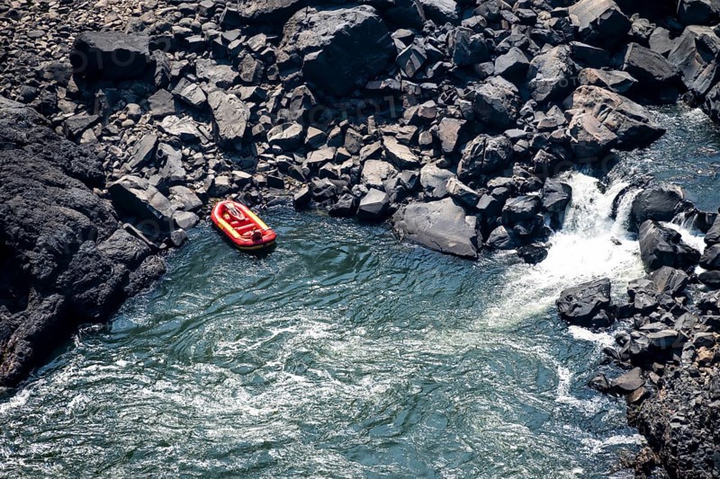 Rafting boat in the river, water plunging into the depths, Victoria Falls, Zambezi, Zimbabwe