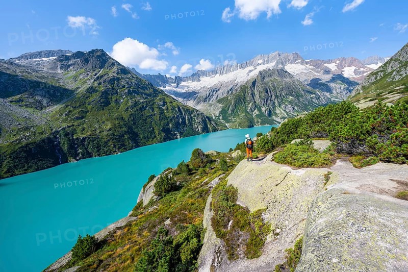 Mountaineers in front of picturesque mountain landscape, turquoise-blue mountain lake Göscheneralpsee, Dammastock and Damma Glacier, Göscheneralp, Canton of Uri, Switzerland