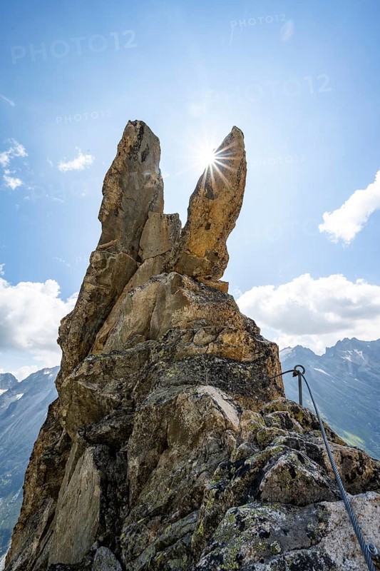 Crocodile rock formation with sun star, via ferrata Krokodil-Bergsee am Bergseeschijen-Vorbau, Göscheneralp, Canton of Uri, Switzerland