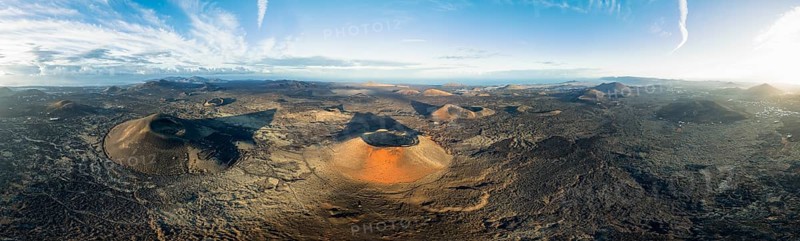 Panorama, Montaña Negra volcano and Caldera Colorada, picturesque volcanic landscape with volcanic crater in morning light, Parque Natural de Los Volcanes, aerial view, Lanzarote, Canary Islands, Spain