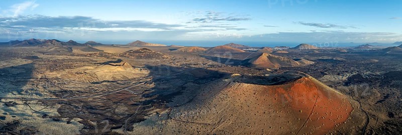 Panorama, Caldera Colorada volcano and Volcán de Las Nueces, picturesque volcanic landscape with volcanic craters in morning light, Parque Natural de Los Volcanes, aerial view, Lanzarote, Canary Islands, Spain