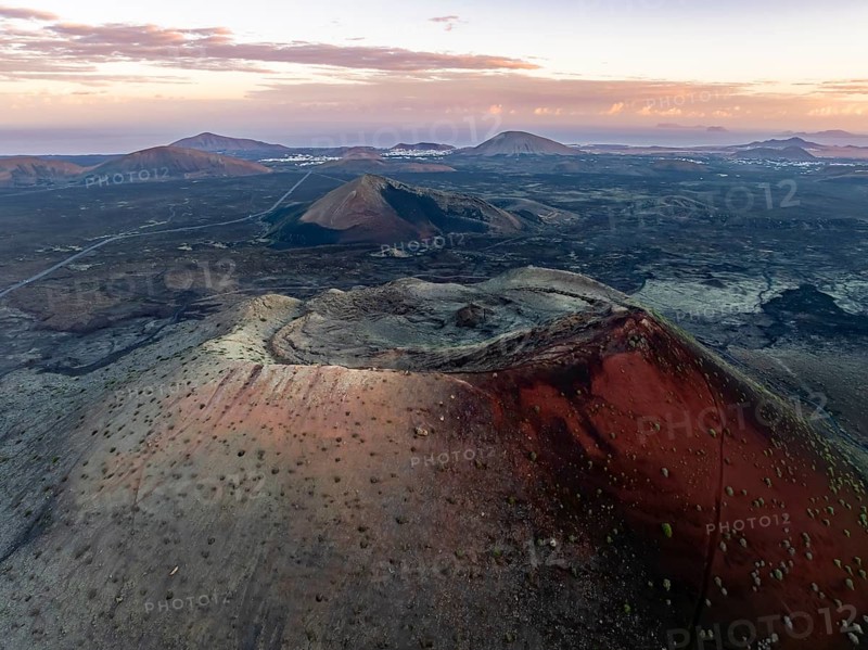 Caldera Colorada volcano, picturesque volcanic landscape with volcanic crater at sunrise, Parque Natural de Los Volcanes, aerial view, Lanzarote, Canary Islands, Spain