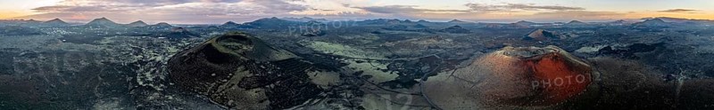 Panorama, Caldera Colorada volcano and Montaña Negra, picturesque volcanic landscape with volcanic craters at sunrise, Parque Natural de Los Volcanes, aerial view, Lanzarote, Canary Islands, Spain