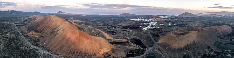 Picturesque volcanic landscape with volcanic craters Montaña de la Tabaiba and Montaña Corujo at sunrise, Parque Natural de Los Volcanes, aerial view, Lanzarote, Canary Islands, Spain