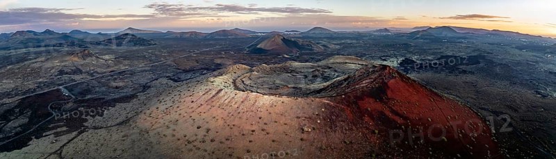 Panorama, Caldera Colorada volcano, picturesque volcanic landscape with volcanic craters at sunrise, Los Volcanes Natural Park, aerial view, Lanzarote, Canary Islands, Spain