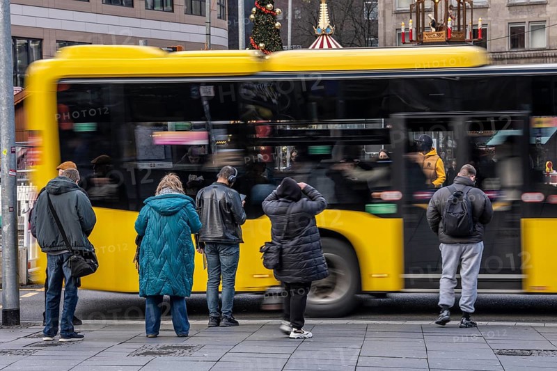 Bus station at Essen main station, Ruhrbahn bus leaves, passers-by wait, Essen, North Rhine-Westphalia, Germany