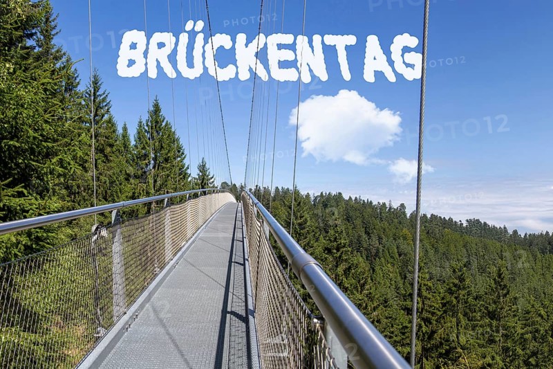Bridge Day Symbolic image: Suspension bridge with font BRÜCKENTAG inserted in the sky (digitally edited)