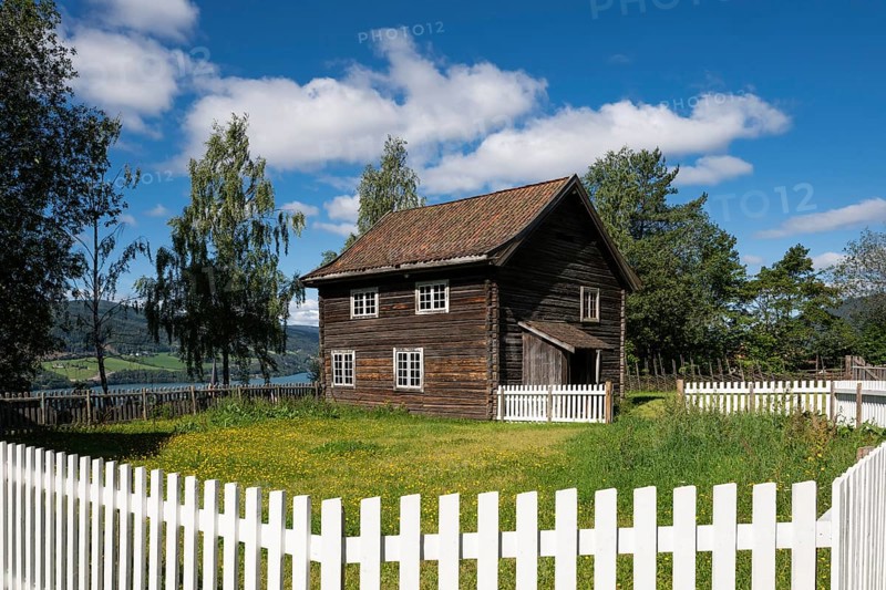 Old farmhouse surrounded by a white-painted fence, Maihaugen open-air museum with houses and objects from farms in Gudbrandsdal, Lillehammer am Mjøsa Lake, Innlandet Fylke Municipality, Norway