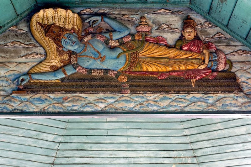 Painted wooden relief, Hindu god Vishnu on the snake Shesha in the primeval sea with wife Lakshmi massaging his feet as a gesture of worship, while from his navel, sitting on a lotus flower, appears the four-person creator Brahma, Kalari Kovilakom, Ayurveda Palace of the Cgh-Earth Hotel Group, Kollengode, Vengunad, Kerala, India