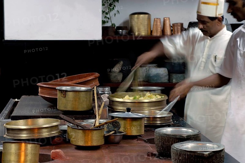 Chefs work in a traditional Tamil kitchen, copper pots and intensive cooking activity, Villa Visalam, Cgh-Earth Hotel Group Hotel, Kanadukathan, Chettinad, Tamil Nadu, India