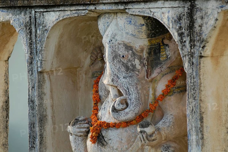 A Ganesha statue decorated with flower garland, Devigarh Palace Hotel, Delwara village near Udaipur, Rajasthan, India