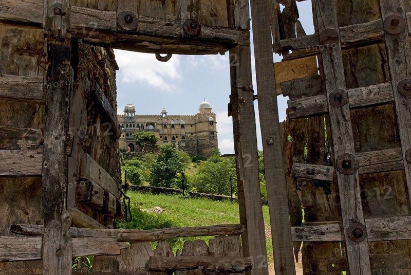 Old, heavily fortified wooden gate, Palasthotel Karni Fort Bambora entrance, Bambora, Rajasthan, India