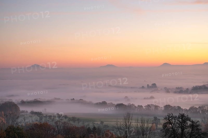 Three Kaiserberge mountains in golden morning light, Hohenstaufen, Aichelberg. Spectacular dawn over the foggy foothills of Baden-Württemberg