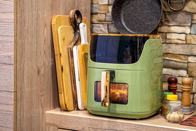 Delicious potato wedges cooking in an air fryer in a cozy kitchen setting