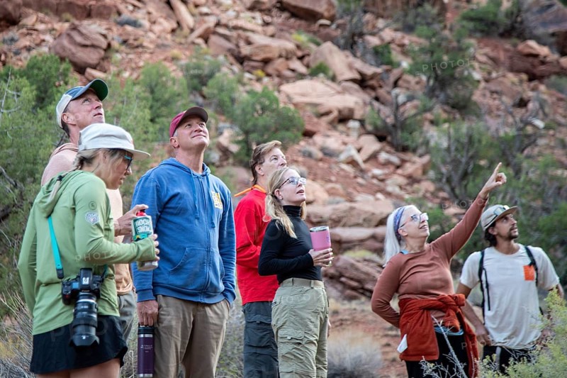 Loma, Colorado - A group of hikers pauses to study rock formations in Ruby Canyon. They were on a three-day river rafting trip on the Colorado River run by Holiday River Expeditions
