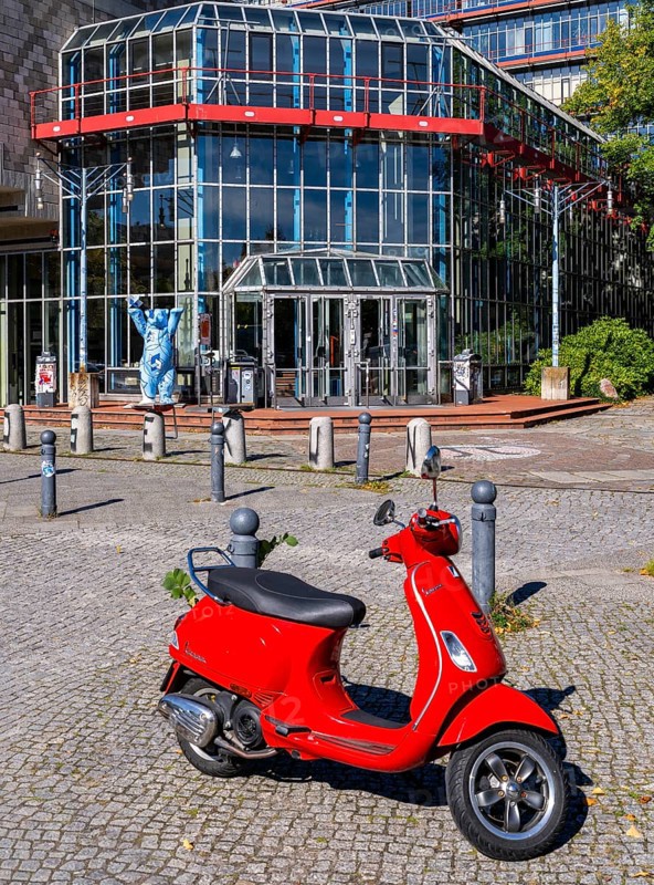 Red Vespa parked in front of the entrance to the Einstein Center for Mathematics building at the Technical University of Berlin on Straße des 17. Juni, Berlin, Germany