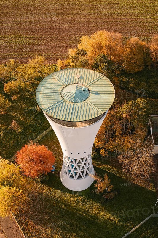 Aerial view of a water tower surrounded by colorful autumn leaves and fields, Möglingen water tower, Germany
