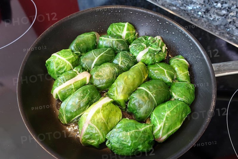 Swabian cuisine, roast tree frogs, stuffed Swiss chard in pan, preparation, stove, ceramic hob, cooking vegetables, vegetarian, vegan, healthy, typically Swabian, grandma's cuisine, traditional cuisine, food photography, studio, Germany