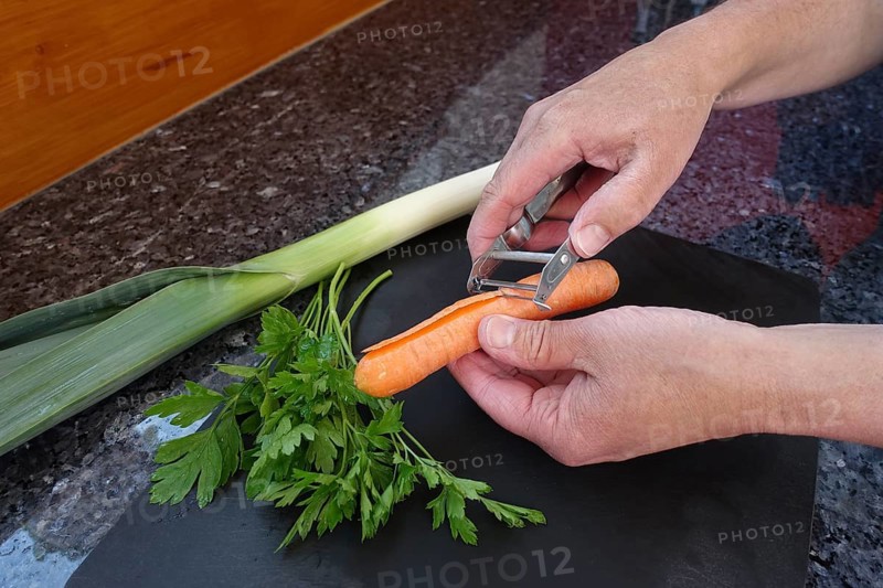 Southern German cuisine, preparation of vegetables, carrot, leek, parsley, raw carrot peel, paring knife, asparagus peeler, men's hands, cutting board, vegetarian, vegan, healthy, food photography, studio, Germany