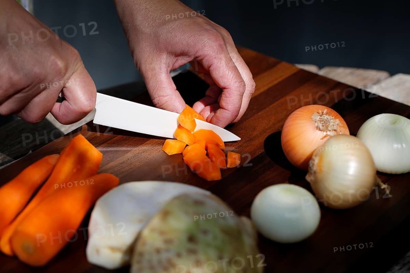 Southern German cuisine, preparing vegetables, cutting raw carrots, celery, onions, vegetarian, vegan, healthy, knife, cutting board, men's hands, traditional cuisine, food photography, studio, Germany