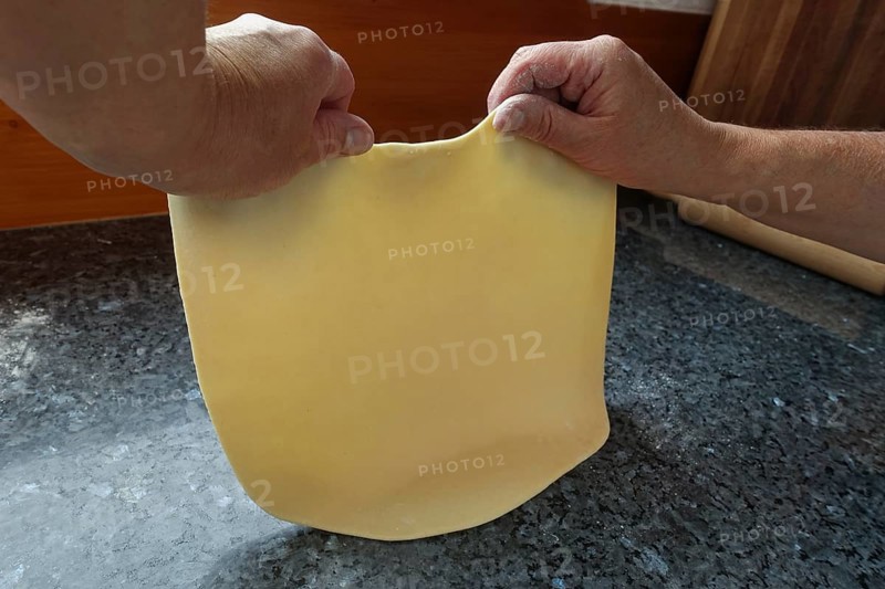 Swabian cuisine, preparing strudel dough, removing raw potato dough, countertop, baking, out of the oven, dough roll, men's hands, typical Swabian, traditional cuisine, food photography, studio, Germany