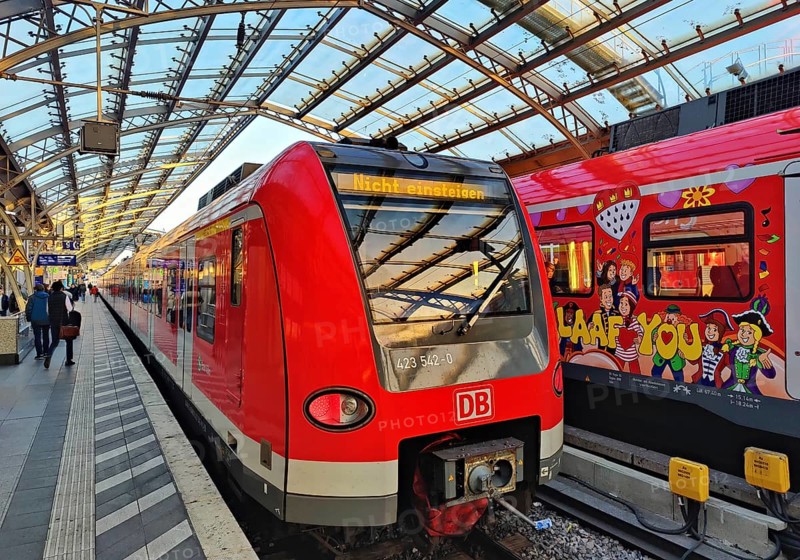 Central Station early in the morning with regional express and S-Bahn with carnival design, Cologne, Rhineland, North Rhine-Westphalia, Germany