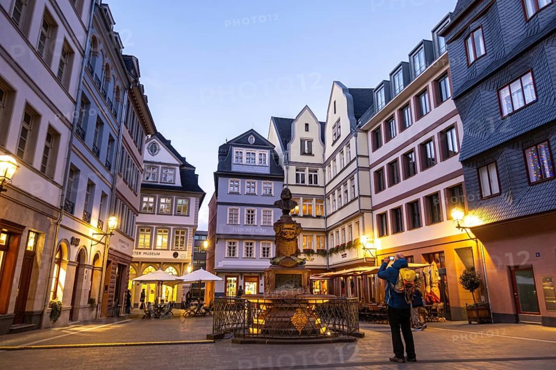 A tourist photographs the Friedrich-Stotlze bust at the chicken market in Frankfurt's New Old Town, New Old Town, Frankfurt am Main, Hesse, Germany