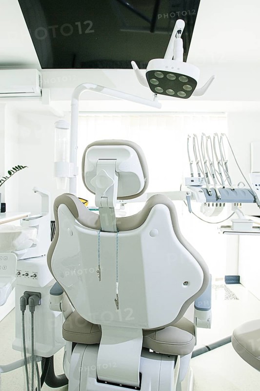 Modern dental clinic with a comfortable chair and equipment for patient care in a bright, clean environment