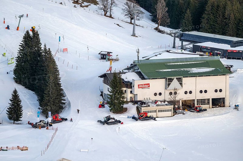 Many snow groomers at the mountain station of the Hochbrixen gondola lift in winter, Skiwelt Wilder Kaiser Brixental, Tyrol, Austria