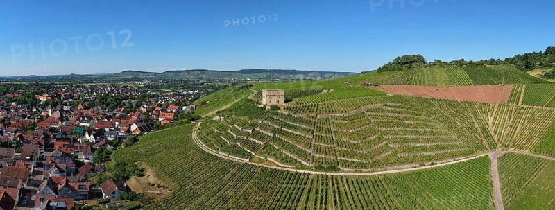 View of vineyards and a village in the hills with a central stone house, Y-Burg, Stetten im Remstal, Baden-Württemberg, Germany