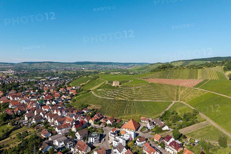 Aerial view of a village next to green vineyards under clear sky, Y-Burg, Stetten im Remstal, Baden-Württemberg, Germany