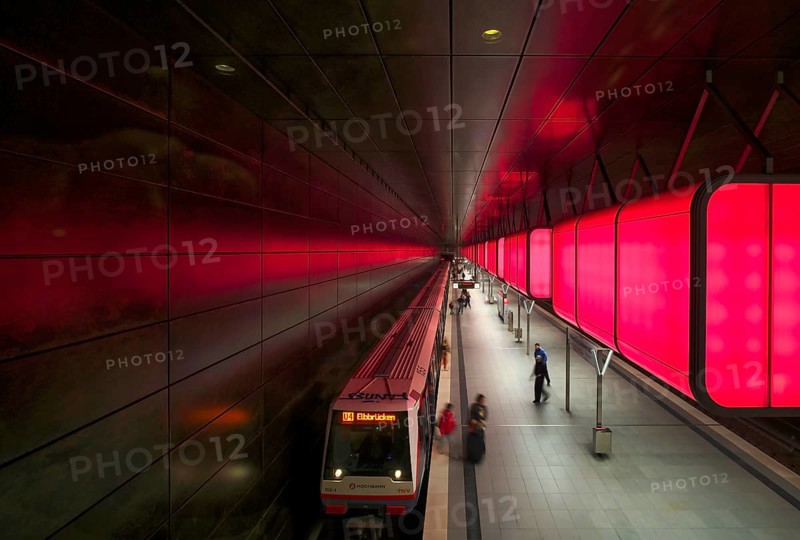 HafenCity University underground station, illuminated in color, red, underground train, U4, travelers, platform, stop, train station, subway, public transport, HVV, Hamburger Verkehrsverbund, Hochbahn, local transport, Free and Hanseatic City of Hamburg, Germany