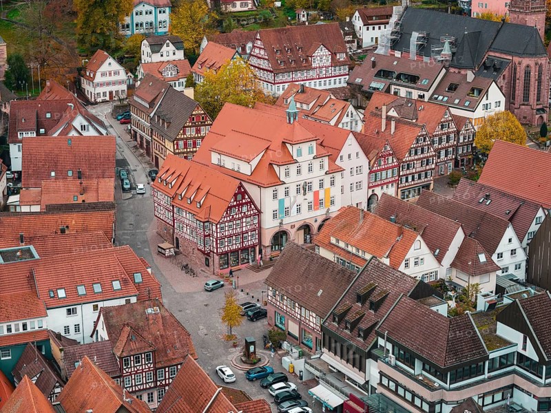 View of traditional city center with half-timbered houses and town hall in autumn atmosphere, Calw, Black Forest, Germany