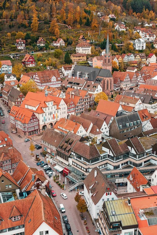 Picturesque city view in autumn with half-timbered houses and church in the middle, Calw, Black Forest, Germany