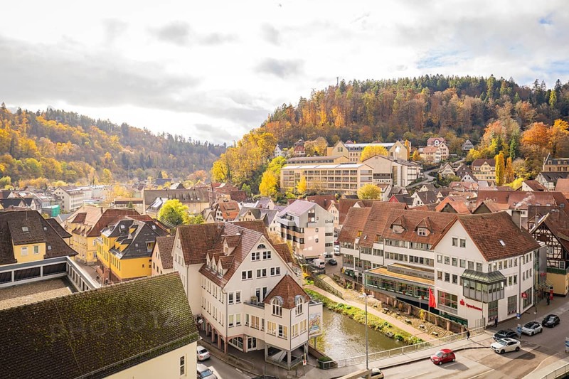 View of the city with autumn trees and hills in the background, Calw, Black Forest, Germany