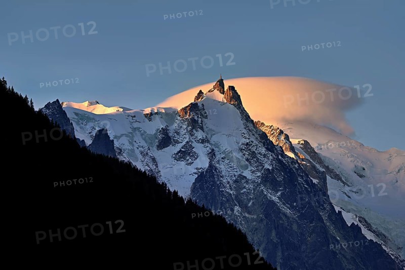 Aiguille du Midi with sun-lit cloud above the summit, Mont-Blanc, Chamonix-Mont-Blanc, Haute-Savoie, France