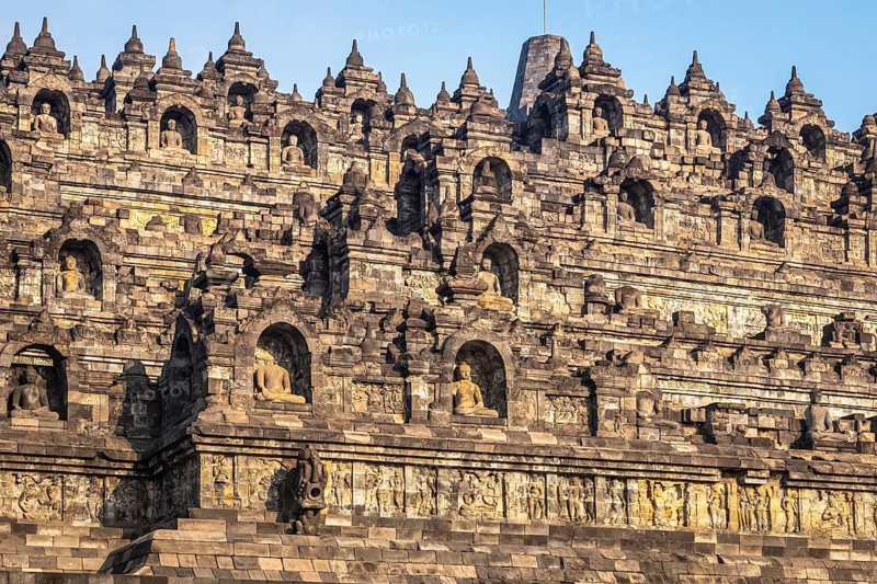 The historic Borobudur temple with its detailed reliefs in Indonesia during daylight, Indonesia