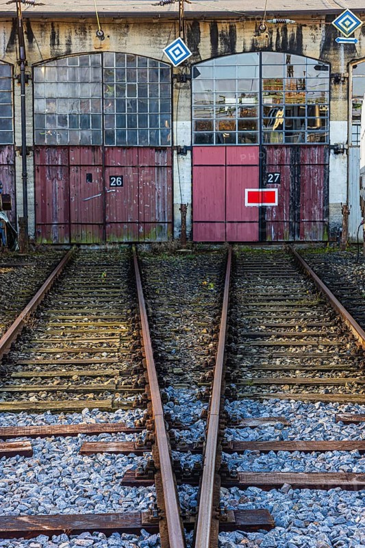 The entrance gates 26 and 27 and railroad tracks of the old engine shed, Augsburg railway park, administrative district of Swabia, Bavaria, Germany