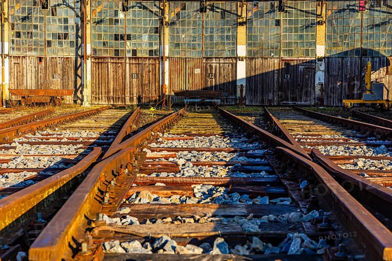 Railroad tracks lead to the entrance gates at the old engine shed, Augsburg railway park, administrative district of Swabia, Bavaria, Germany